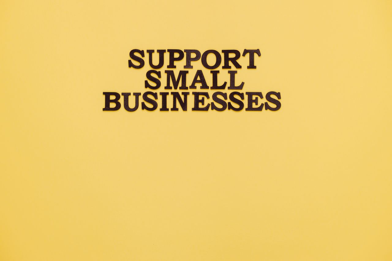 about-us-01 Inspirational image with 'Support Small Businesses' text on a warm yellow background.